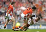 23 July 2005; Aaron Kernan (5), Armagh, tussles with Philip Jordan, Tyrone, as Paddy McKeever, Armagh, attempts to intervene. Bank of Ireland Ulster Senior Football Championship Final Replay, Tyrone v Armagh, Croke Park, Dublin. Picture credit; Brendan Moran / SPORTSFILE