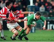 11 November 2000; Ronan O'Gara, Ireland, is tackled by Hiroyuki Tanuma, Japan. International Rugby Friendly, Ireland v Japan, Lansdowne Road, Dublin. Picture credit: Ray Lohan / SPORTSFILE
