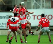 11 April 1999; Anthony Tohill of Derry gains possession ahead of Nicholas Murphy of Cork during the Church and General National Football League Quarter-Final match between Cork and Derry at Croke Park in Dublin. Photo by Ray McManus/Sportsfile
