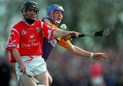 18 April 1999; Ben O'Connor of Cork in action against Eugene Furlong of Wexford during the Church & General National Hurling League Division 1B match between Wexford and Cork at Páirc Uí Shíocháin in Gorey, Wexford. Photo by Ray McManus/Sportsfile