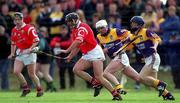 18 April 1999; Brian Corcoran of Cork in action against Chris McGrath of Wexford during the Church & General National Hurling League Division 1B match between Wexford and Cork at Páirc Uí Shíocháin in Gorey, Wexford. Photo by Ray McManus/Sportsfile