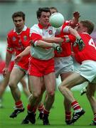 11 April 1999; Joe Brolly of Derry in action against Anthony Lynch, Padraig O'Mahony and Owen Sexton of Cork during the Church and General National Football League Quarter-Final match between Cork and Derry at Croke Park in Dublin. Photo by Ray McManus/Sportsfile
