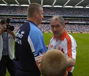 27 August 2005; Tyrone manager Mickey Harte shakes hands with Dublin manager's Paul Caffrey with his son Eric at the final whistle. Bank of Ireland All-Ireland Senior Football Championship Quarter-Final Replay, Dublin v Tyrone, Croke Park, Dublin. Picture credit; Damien Eagers / SPORTSFILE