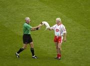 27 August 2005; Tyrone's Owen Mulligan hands a stray dog to referee Gerry Kinneavy during the game. Bank of Ireland All-Ireland Senior Football Championship Quarter-Final Replay, Dublin v Tyrone, Croke Park, Dublin. Picture credit; Ray McManus / SPORTSFILE