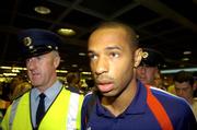 6 September 2005; theirry Henry, member of the French squad, with Paul Clarke, left, a member of the Aiport police and current selector of the Dublin football team, pictured on arrival at Dublin Airport in advance of the World Cup Qualifying game against the Republic of Ireland. Dublin Airport, Dublin. Picture credit; Damien Eagers / SPORTSFILE