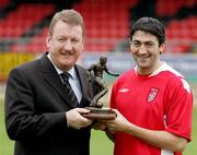 5 October 2005; Derry City's Peter Hutton who was presented with the eircom / Soccer Writers Association of Ireland Player of the Month award for September with Jim Roddy, Derry City commercial director. Brandywell, Derry. Picture credit; Lorcan Doherty / SPORTSFILE