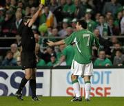 12 October 2005; Andy Reid, Republic of Ireland, is shown the yellow card by referee Markus Merk. FIFA 2006 World Cup Qualifier, Group 4, Republic of Ireland v Switzerland, Lansdowne Road, Dublin. Picture credit: Brian Lawless / SPORTSFILE