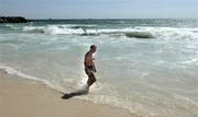 20 October 2005; Ireland manager Pete McGrath walks to the water for a swim, in the Indian Ocean, at Cottesloe Beach advance of the Fosters International Rules game between Australia and Ireland. Cottesloe, Perth, Western Australia. Picture credit; Ray McManus / SPORTSFILE