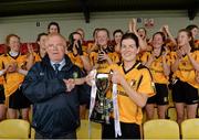 5 April 2014; Coláiste Íosagáin team captain Aedini Ni Dhonaill is presented with the cup by Peter Rice, Treasurer of the LGFA. TESCO HomeGrown Post Primary School Senior A Final, Coláiste Dún Iascaigh, Cahir v Coláiste Íosagáin, Stillorgan. Dr. Cullen Park, Carlow. Picture credit: Matt Browne / SPORTSFILE