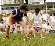 24 January 2006; Wexford's Adrian Fenlon, who played during the GAA Vodafone All-Stars Exhibition Game, with eight year old Uihun who is a pupil at the Overseas Family School, Patterson Road, Singapore, during a coaching session at the school. Picture credit; Ray McManus / SPORTSFILE