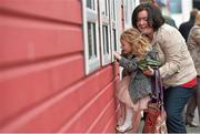 30 April 2014; Caitlinn Reddy, age 4 from Blessington, Co.Wicklow, is lifted up by her aunt Mary Ryan as she  purchases her racecard ahead of the day's races. Punchestown Racecourse, Punchestown, Co. Kildare. Picture credit: Barry Cregg / SPORTSFILE