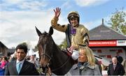 30 April 2014; Jockey Ruby Walsh salutes the crowd on Boston Bob as he is led into the winners enclosure by owner Andrea Wylie after winning the Bibby Financial Services Ireland Punchestown Gold Cup. Punchestown Racecourse, Punchestown, Co. Kildare. Picture credit: Barry Cregg / SPORTSFILE