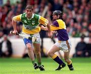 20 June 1999; Michael Duignan of Offaly in action against Sean Flood of Wexford during the Guinness Leinster Senior Hurling Championship semi-final match between Offaly and Wexford at Croke Park in Dublin. Photo by Ray McManus/Sportsfile
