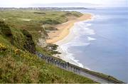 10 May 2014; The peloton passes Portrush beach on the Dunluce Road during stage 2 of the Giro d'Italia 2014. Belfast - Belfast. Picture credit: Stephen McCarthy / SPORTSFILE