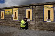 2 April 2006; Longford steward Jimmy McDonnell fixes a sign outside the ticket sales booths. Cadburys Leinster U21 Football Final, Longford v Laois, Pearse Park, Longford. Picture credit: Ray McManus / SPORTSFILE