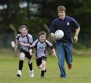 6 April 2006; Aoife Nolan and James Cribin, left, both aged 8, from Ballyhaunis, Co. Mayo, chase Billy Joe Padden, Mayo, at the launch of the Connacht Vhi Cúl Camps. Inter county stars from all over Connacht were present to announce details of the popular Summer Camps which start on July 3rd. The Vhi Cúl Camps are a nationally co-ordinated programme that aims to encourage children to learn and develop sporting and life-skills by particpating in Gaelic Games, in a fun, non-competitive environment. Ballyhaunis, Co. Mayo. Picture credit: David Maher / SPORTSFILE