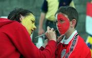 4 July 1999; A Cork supporter has his face painted prior to  the Munster Senior Hurling Championship Final match between Cork and Clare at Semple Stadium in Thurles, Tipperary. Photo by Damien Eagers/Sportsfile