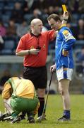 16 April 2006; Robbie Stakelum, Longford, is booked by referee John Devlin after fouling Donegal's Colm Breathnach. Allianz National Hurling League, Division 3 Semi-Final, Donegal v Longford, Kingspan Breffni Park, Cavan. Picture credit: Damien Eagers / SPORTSFILE