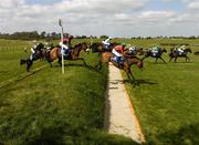 27 April 2006; The runners and riders make their way over the double bank during the Blue Square Chase For The La Touche Cup. Punchestown Racecourse, Co. Kildare. Picture credit: Matt Browne / SPORTSFILE