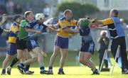 1 July 2006; Clare manager Anthony Daly holds his balance while Clare's Colin Lynch and Dublin's Liam Ryan tussle. Guinness All-Ireland Senior Hurling Championship Qualifier, Round 2, Dublin v Clare, Parnell Park, Dublin. Picture credit: Ray Lohan / SPORTSFILE
