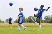 5 July 2006; Ryan Lee Cleary, age 9, from Kentstown, and Nonso Anny-Nzekwue, age 9, from Warrenstown, taking part at the Pepsi FAI Summer Soccer School at Blanchardstown IT. This particular camp was partially funded by various local groups in the area and the FAI. The Pepsi FAI Summer Soccer Schools run until the end of August in over 200 locations nationwide. See www.fai.ie for more details. Blanchardstown IT, Blanchardstown, Co. Dublin. Picture credit: Brian Lawless / SPORTSFILE