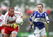 8 July 2006; Ross Munnelly, Laois, in action against Stephen O'Neill, Tyrone. Bank of Ireland All-Ireland Senior Football Championship Qualifier, Round 2, Laois v Tyrone, O'Moore Park, Portlaoise, Co. Laois. Picture credit: Oliver McVeigh / SPORTSFILE