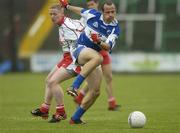 8 July 2006; Tom Kelly, Laois, in action against Colm McCullagh, Tyrone. Bank of Ireland All-Ireland Senior Football Championship Qualifier, Round 2, Laois v Tyrone, O'Moore Park, Portlaoise, Co. Laois. Picture credit: Brendan Moran / SPORTSFILE