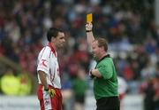 8 July 2006; Ryan McMenamin, Tyrone, is shown a yellow card by referee John Geaney. Bank of Ireland All-Ireland Senior Football Championship Qualifier, Round 2, Laois v Tyrone, O'Moore Park, Portlaoise, Co. Laois. Picture credit: Brendan Moran / SPORTSFILE