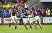 6 July 2014; John O'Loughlin, Laois, in action against Daithí Waters, left, and Conor Carty, Wexford.  GAA Football All Ireland Senior Championship, Round 2a, Wexford v Laois, Wexford Park, Wexford. Picture credit: Barry Cregg / SPORTSFILE