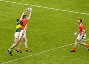 5 August 2006; Ronan Clarke, under pressure from the Kerry full-back Michael McCarthy, knocks the ball down to his Armagh team-mate Steven McDonnell who went on to score his side's first goal.  Bank of Ireland All-Ireland Senior Football Championship Quarter-Final, Armagh v Kerry, Croke Park, Dublin. Picture credit; Ray McManus / SPORTSFILE