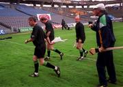 8 August 1999; Offaly manager Michael Bond, right, attempts to have a word with Referee Dickie Murphy, 2nd from left, as he and his linesmen leave the field at half time during the Guinness All-Ireland Hurling Senior Championship Semi-Final match between Cork and Offaly at Croke Park in Dublin. Photo by Brendan Moran/Sportsfile