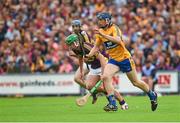 12 July 2014; David McInerney, Clare, prepares to clear under pressure from Conor McDonald, Wexford. GAA Hurling All-Ireland Senior Championship Round 1 Replay, Clare v Wexford, Wexford Park, Wexford. Picture credit: Ray McManus / SPORTSFILE
