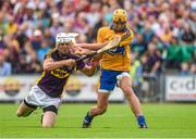 12 July 2014; Clare's John Conlon has his shot blocked by Wexford's Ciaran Kenny, leading up to the second Clare goal. GAA Hurling All-Ireland Senior Championship Round 1 Replay, Clare v Wexford, Wexford Park, Wexford. Picture credit: Ray McManus / SPORTSFILE