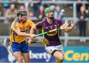 12 July 2014; Matthew O'Hanlon, Wexford, clears under pressure from Clare's Colin Ryan in the last minutes of the game. GAA Hurling All-Ireland Senior Championship Round 1 Replay, Clare v Wexford, Wexford Park, Wexford. Picture credit: Ray McManus / SPORTSFILE