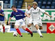 19 August 2006; Jamie Mulgrew, Linfield, is tackled by James Bell, Lisburn Distillery. CIS Insurance Cup, Linfield v Lisburn Distillery, Windsor Park, Belfast, Co. Antrim. Picture credit: Oliver McVeigh / SPORTSFILE