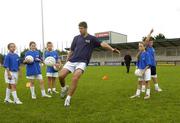 23 August 2006; Former Republic of Ireland international Niall Quinn shows off his football skills to children from Dublin's Docklands during the Dublin Docklands Festival of Hurling and Gaelic Football which is sponsored by the Dublin Docklands Development Authority. Parnell Park, Dublin. Picture credit: Pat Murphy / SPORTSFILE