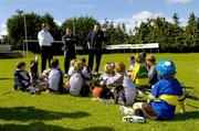 24 August 2006; Dublin footballer and hurler Conal Keaney, right, Paraic McDonald, Director of Coaching, Kilmacud Crokes GAA Club, and Declan Moran, left, Vhi, speak to young players at the announcement by the GAA that a record 75,000 children attended the Official GAA Vhi Cúl Camps this summer. Kilmacud Crokes GAA Club, Stillorgan, Dublin. Picture credit; Matt Browne / SPORTSFILE
