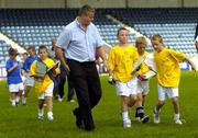 24 August 2006; Dublin football Manager Paul Caffrey with young children from the Docklands who he presented with certificates for participating in the Docklands Festival of Hurling and Gaelic Football. Parnell Park, Dublin. Picture credit; Brian Lawless / SPORTSFILE