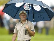 22 September 2006; Paul McGinley, Team Europe 2006, holding an umbrella during Friday afternoon's foursomes matches. 36th Ryder Cup Matches, K Club, Straffan, Co. Kildare, Ireland. Picture credit: Matt Browne / SPORTSFILE