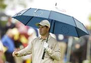 22 September 2006; Padraig Harrington, Team Europe 2006, covers himself from the rain during Friday afternoon's foursomes matches. 36th Ryder Cup Matches, K Club, Straffan, Co. Kildare, Ireland. Picture credit: Matt Browne / SPORTSFILE