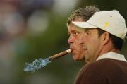 22 September 2006; Darren Clarke, Team Europe 2006, smokes a cigar alongside team-mate Jose Maria Olazabal, during Friday afternoon's foursomes matches. 36th Ryder Cup Matches, K Club, Straffan, Co. Kildare, Ireland. Picture credit: Matt Browne / SPORTSFILE
