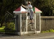 2 October 2006; Sr. Breege Brennan, a member of the Marist Convent, repaints the piers of St. Joseph's, Charlestown, Co. Mayo, white after Mayo's attempts to win the Sam Maguire. Sr Brennan is originally from Sligo and her brother John played at full-back for Sligo against Kerry in the All-Ireland semi-final in 1975. Picture credit: Ray McManus / SPORTSFILE