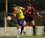 3 October 2006; Chris Morrow, Crusaders, heads in the first goal under pressure from Bryan McChrystal, Newry City. CIS Insurance Cup Quarter-Final, Crusaders v Newry, Seaview, Belfast. Picture credit: Oliver McVeigh / SPORTSFILE