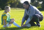 1 November 2006; Former Republic of Ireland star John Aldridge helps Carly Swane, age 8, from Pearse St., lace up her boots at the launch of the second Docklands Soccer Camp and Mini World Cup Tournament. This is the second year of The Dublin Docklands Soccer Camp to provide young people from the Docklands the opportunity to develop their soccer skills. This two day event takes place on Wednesday 1st November and Thursday 2nd November 2006. ALSAA Sports Complex, Dublin. Picture credit: Brian Lawless / SPORTSFILE