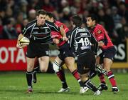 25 November 2006; Nikki Walker, supported by Shaun Connor,  10 , Neath Swansea Ospreys, is tackled by Trevor Halstead , Munster. Magners League, Munster v Neath Swansea Ospreys, Thomond Park, Limerick. Picture credit: Kieran Clancy / SPORTSFILE