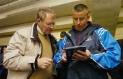 14 January 2007; Dublin manager Paul Caffrey, right, fills in the changes on the match programme in the dressing room before the start of the game for RTE commentator Micheal O Muircheartaigh. O'Byrne Cup Quarter-Final, Westmeath v Dublin, Cusack Park, Mullingar, Co. Westmeath. Picture credit: David Maher / SPORTSFILE