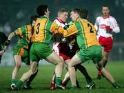 17 February 2007; Colm McCullagh, Tyrone, is tackled by Donegal players Eamon McGee, Paddy McConigley and Paddy Campbell. McKenna Cup Final, Donegal v Tyrone, Healy Park, Omagh, Co. Tyrone. Picture credit: Oliver McVeigh / SPORTSFILE