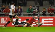 19 September 2014; Andrew Smith, Munster, scores his side's fourth try despite the efforts of David Odiete, Zebre. Guinness PRO12, Round 3, Munster v Zebre. Thomond Park, Limerick. Picture credit: Diarmuid Greene / SPORTSFILE