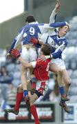 25 February 2007; Brendan Quigley, left, and Pauric Clancy, Laois, in action against Paddy Keenan, Louth. Allianz National Football League, Division 1B, Round 3, Laois v Louth, O'Moore Park, Portlaoise, Co. Laois. Photo by Sportsfile *** Local Caption ***