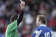 25 February 2007; Joe Higgins, Laois, receives a yellow card from referee Syl Doyle. Allianz National Football League, Division 1B, Round 3, Laois v Louth, O'Moore Park, Portlaoise, Co. Laois. Photo by Sportsfile *** Local Caption ***